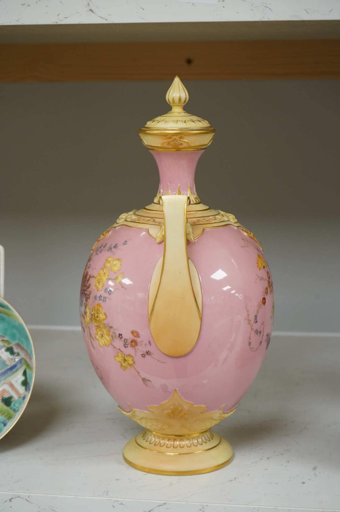 A Royal Worcester floral decorated two handled vase and cover, 30cm